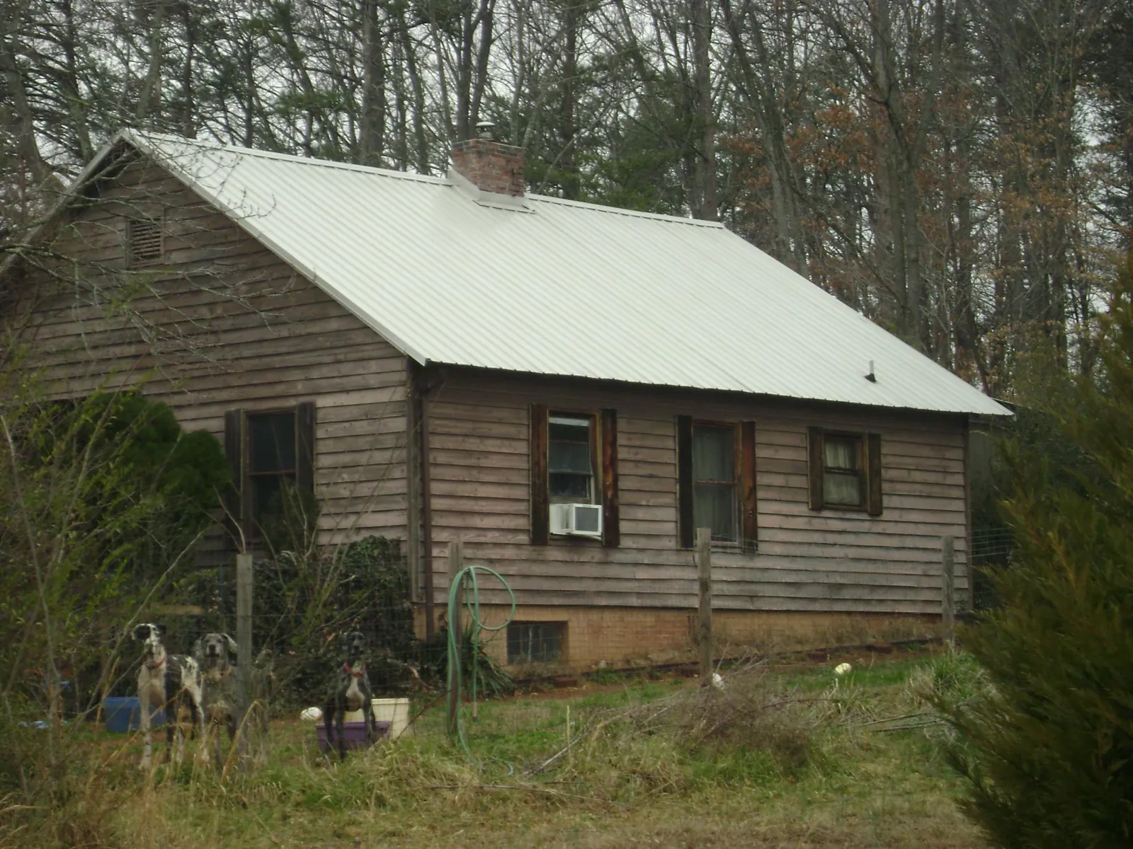 White metal roof on an old wood sided farmhouse, from a Metal Roof Installation job in East Taunton